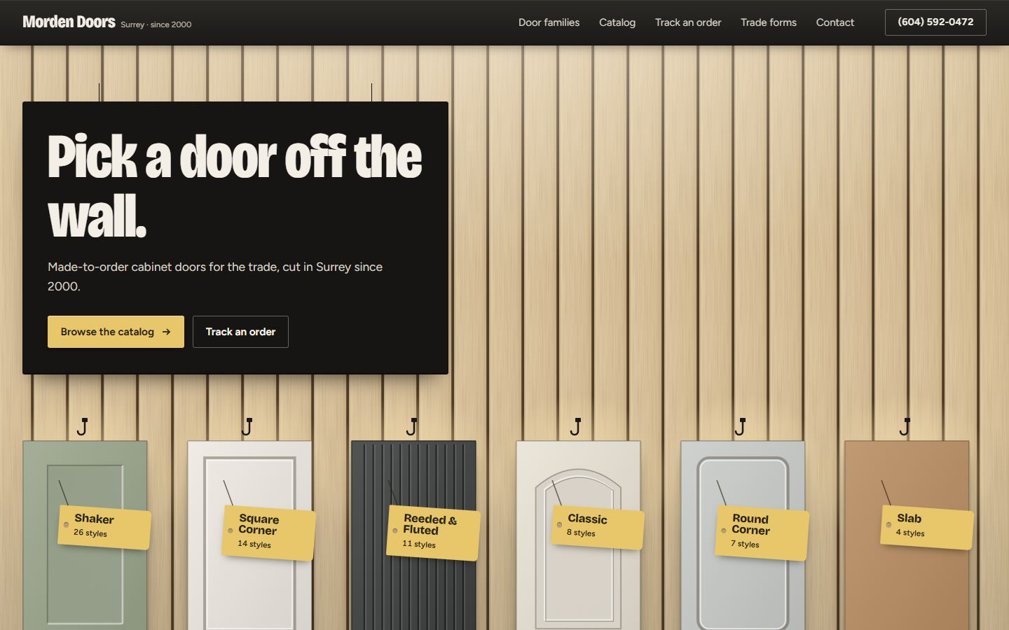 Showroom Door Wall home page: six doors hanging on a birch slat wall
